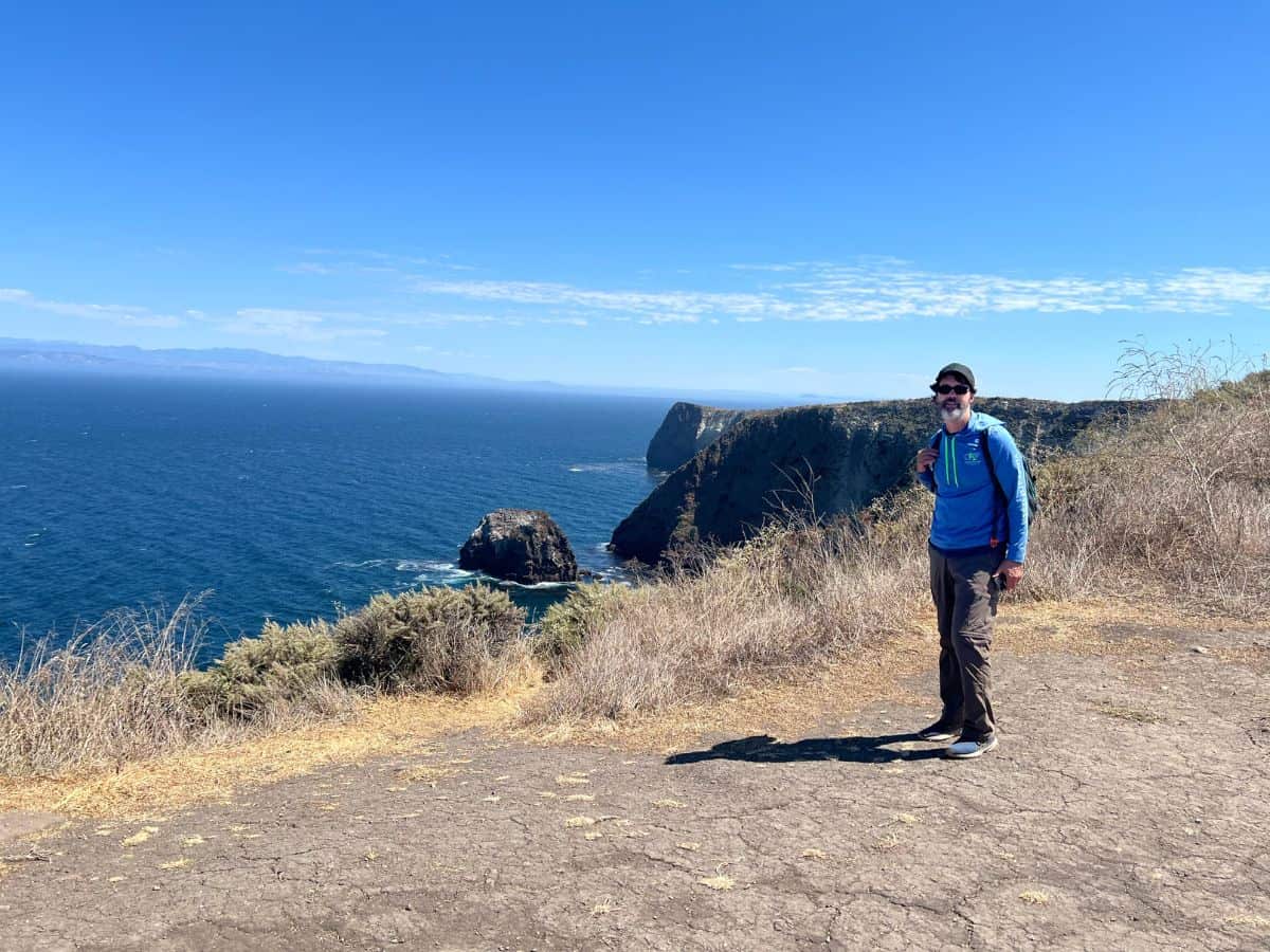 A man hikes along the coast on Santa Cruz Island, CA