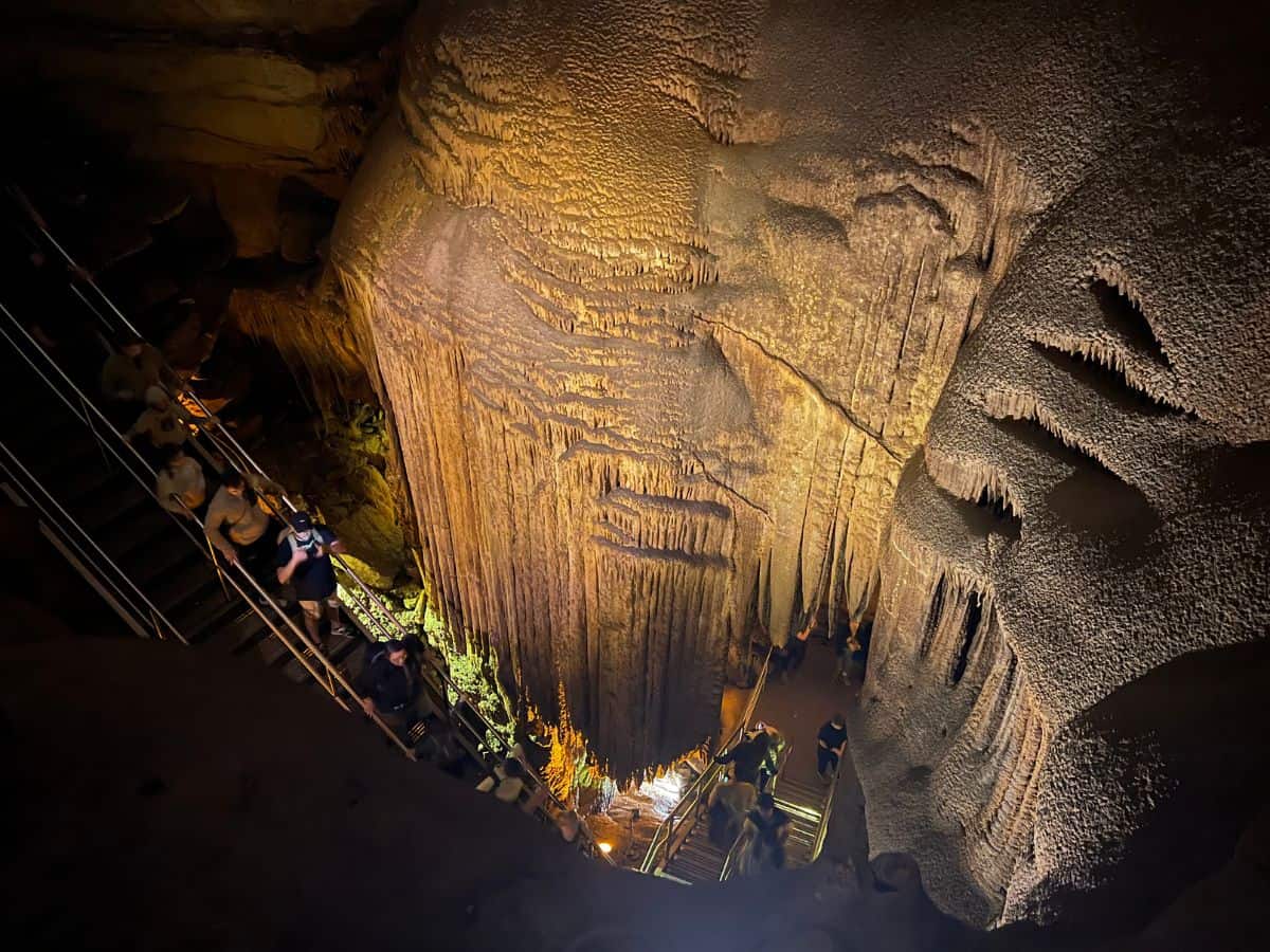 A park ranger leads visitors down a staircase inside Mammoth Cave, KY