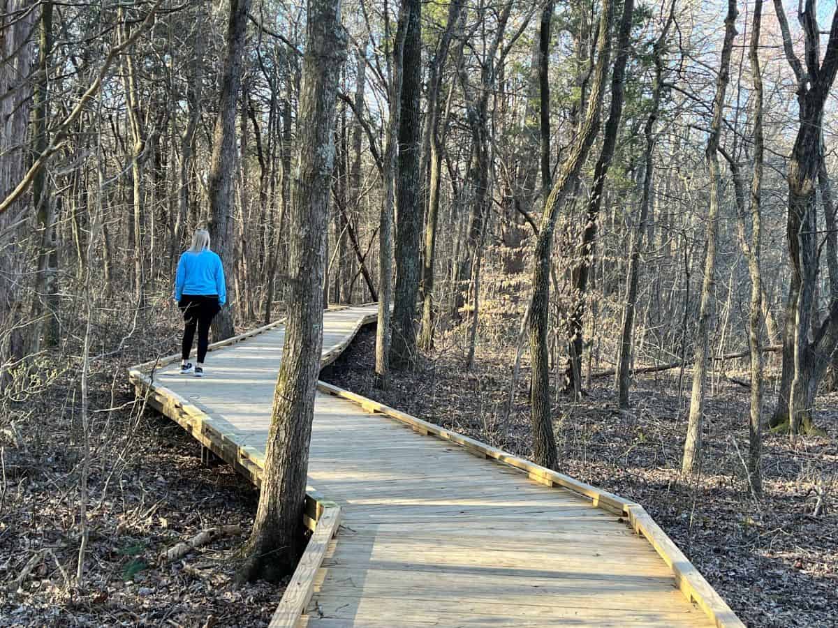 A woman hikes along a boardwalk trail in Mammoth Cave National Park, KY