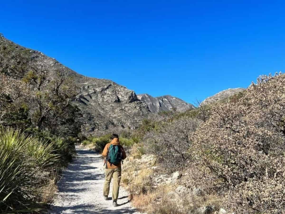 A man hikes a rugged trail in the Guadalupe Mountains