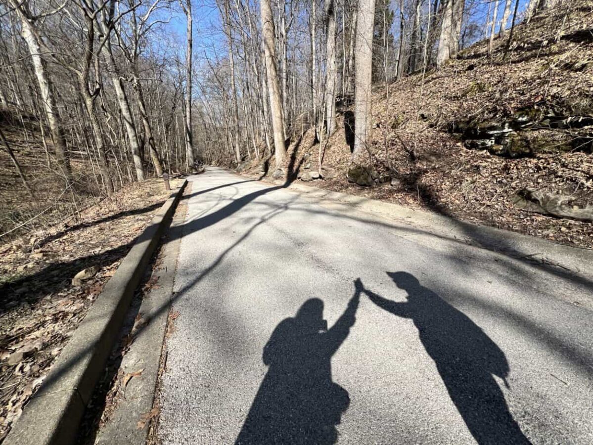 Shadows of a man and woman giving each other a high five