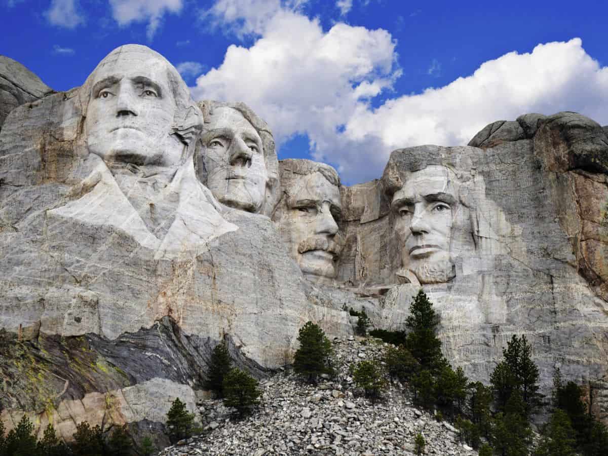 White clouds hover over Mount Rushmore