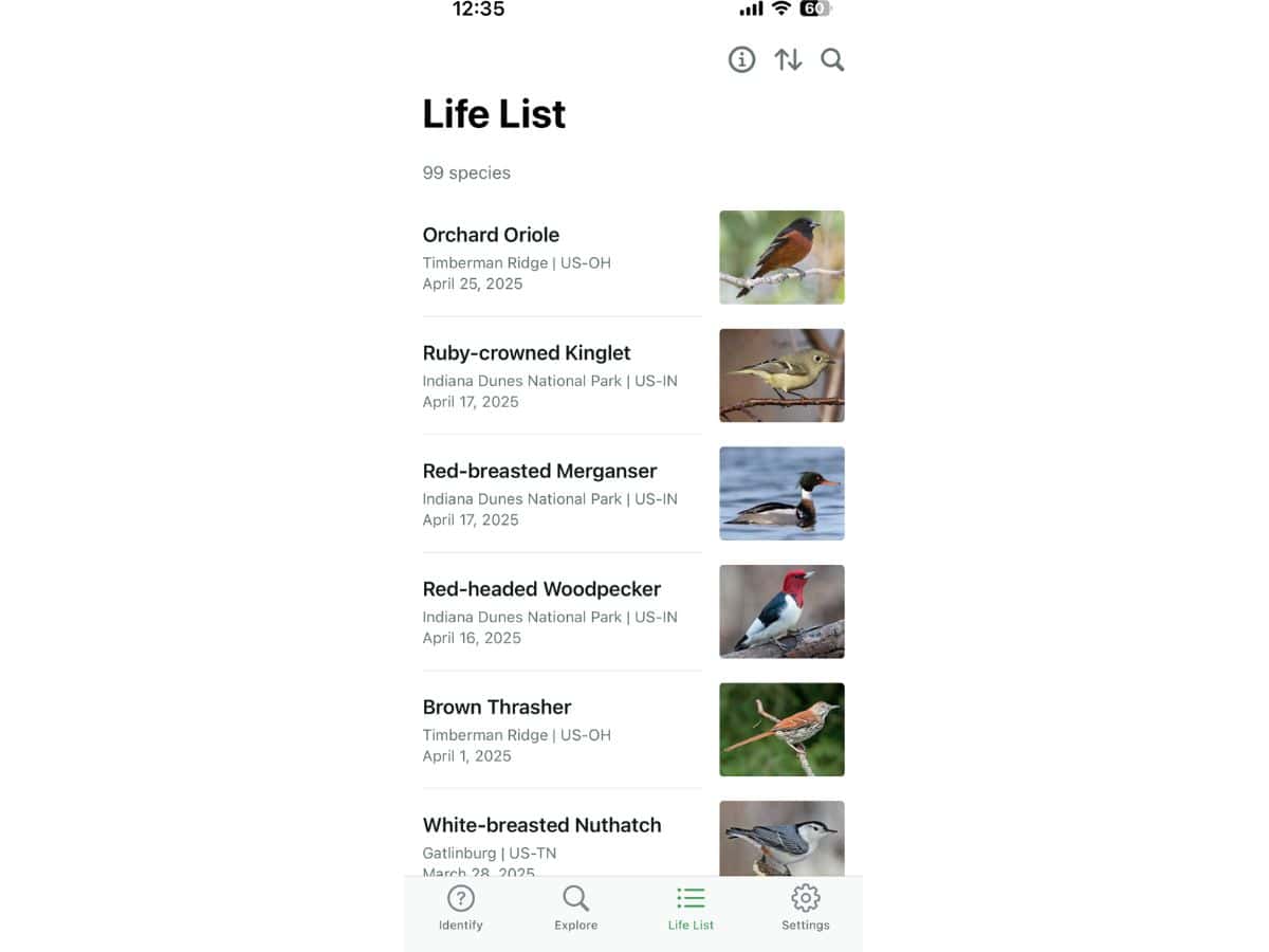 A phone screen displays a life list of birds spotted