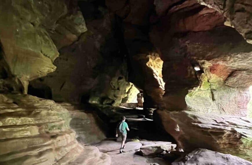 A man walks through a rock house in Hocking Hills State Park, Ohio