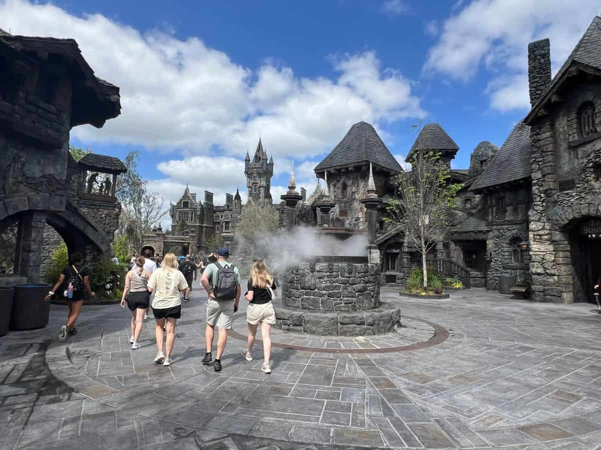 Guests walk through Darkmoor in Epic Universe's Dark Universe world
