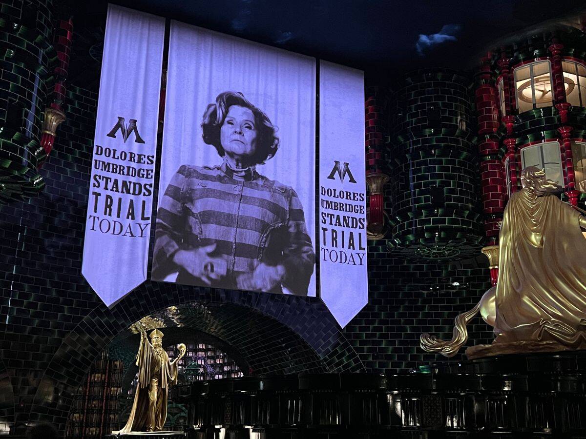 An image of Dolores Umbridge shows in the background in the ride queue for Harry Potter and the Battle at the Ministry.