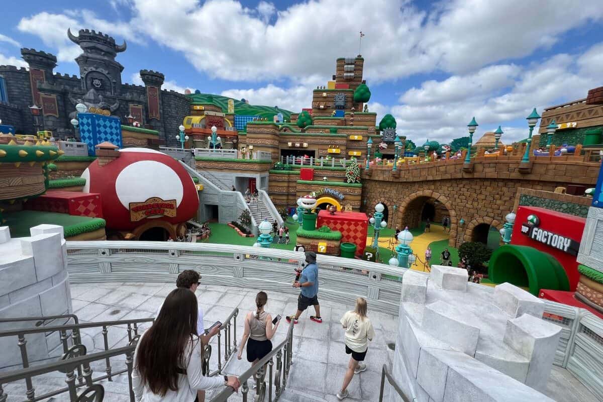 A family walks down a set of stairs into Super Mario Land in Super Nintendo World.