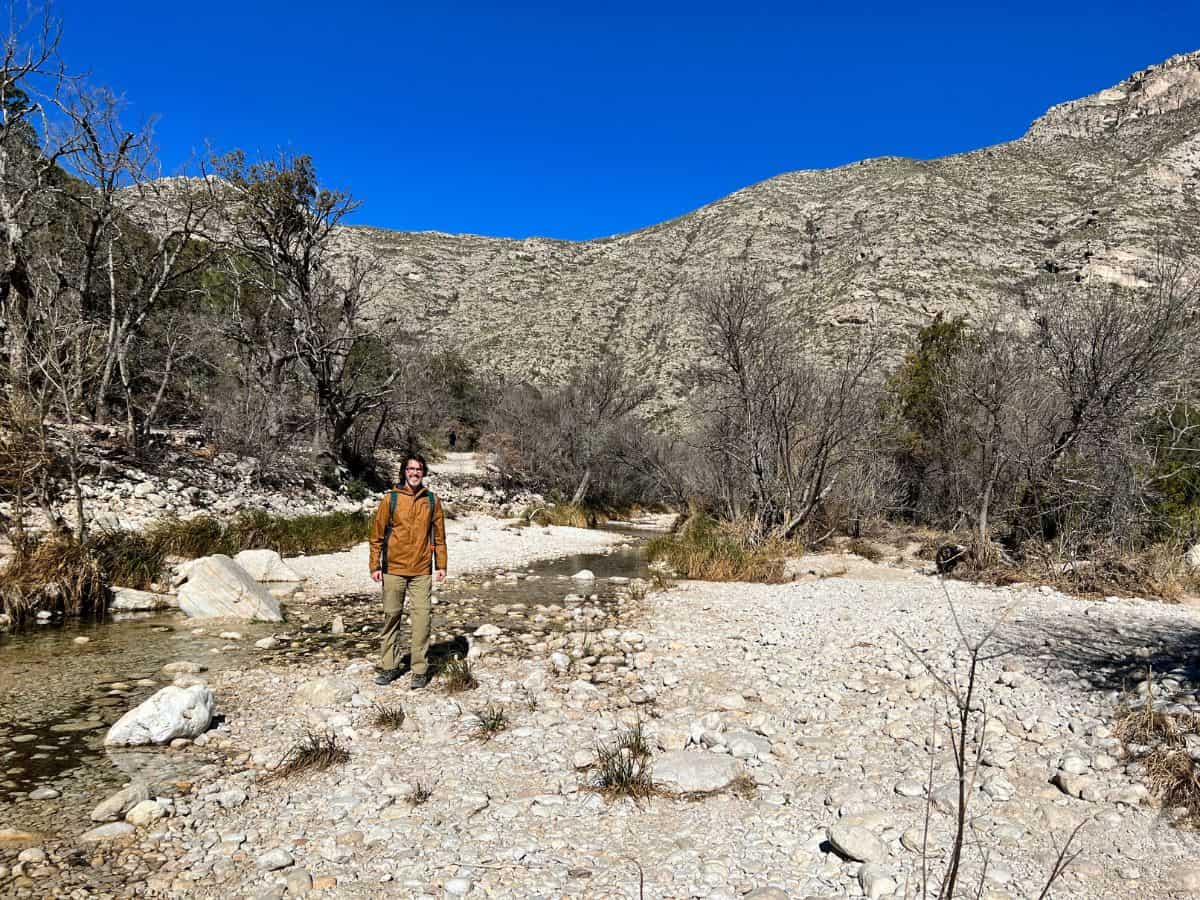 A man hikes in Guadalupe Mountains National Park with nobody else in sight.