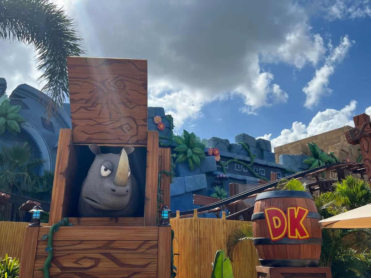 A rhino pokes his head out of a crate in Donkey Kong Country, Epic Universe, Orlando, Florida.