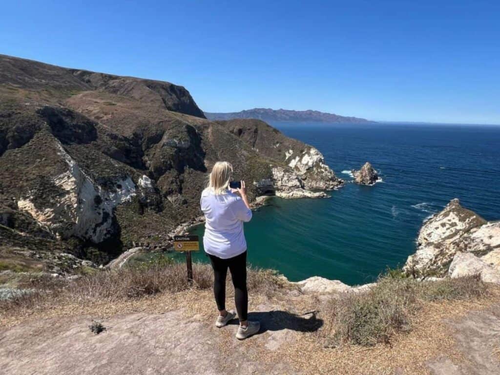 Julie takes pictures along the coast of Santa Cruz Island, CA as part of our Channel Islands National Park review.