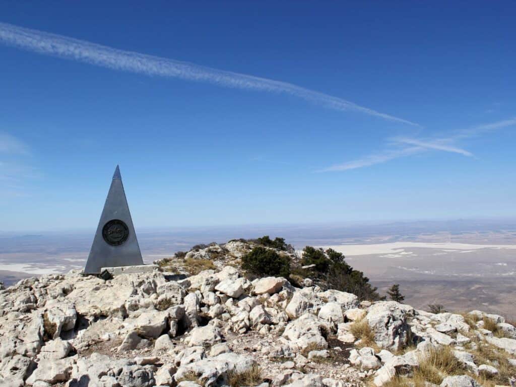 A triangular shaped plaque notes that Guadalupe Peak is the highest point in Texas