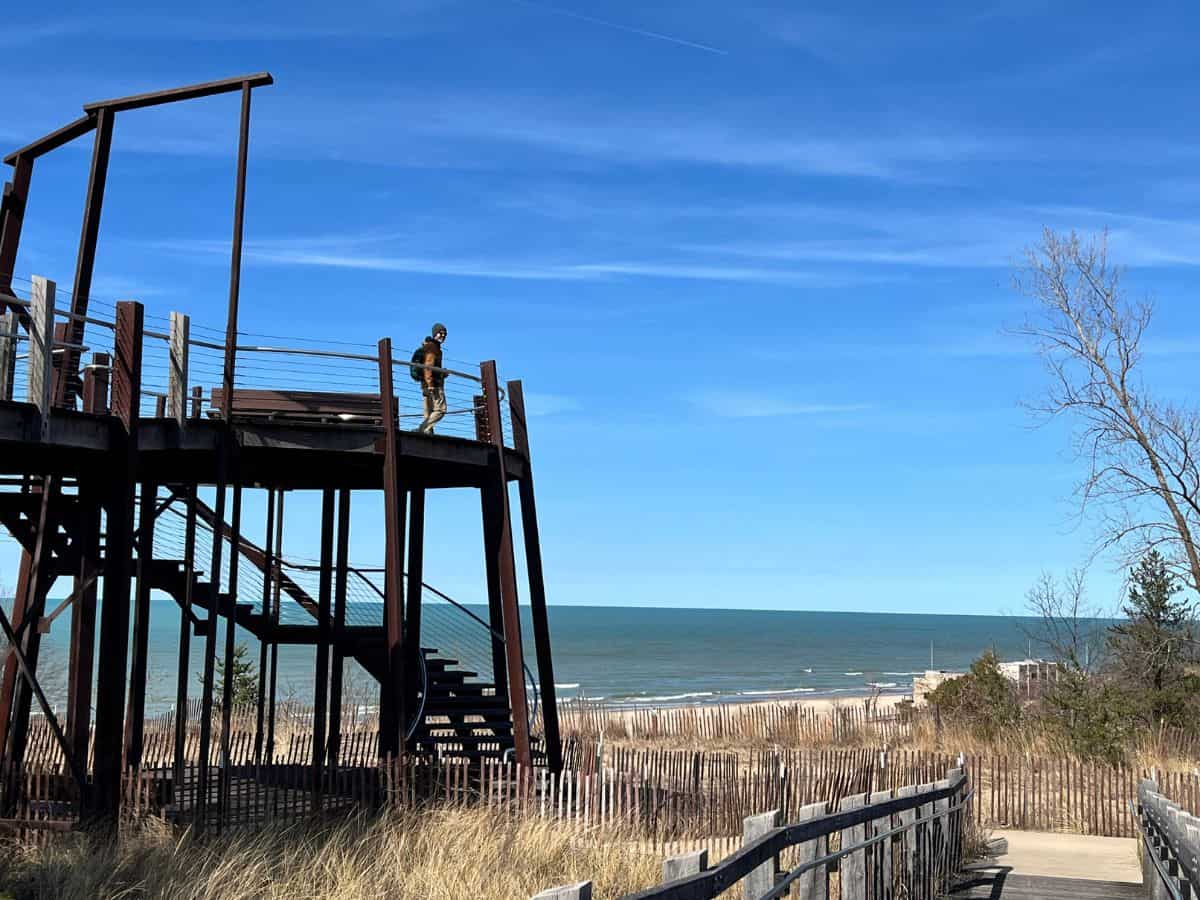 A man walks to the edge of a birding platform in Indiana Dunes along Lake Michigan.