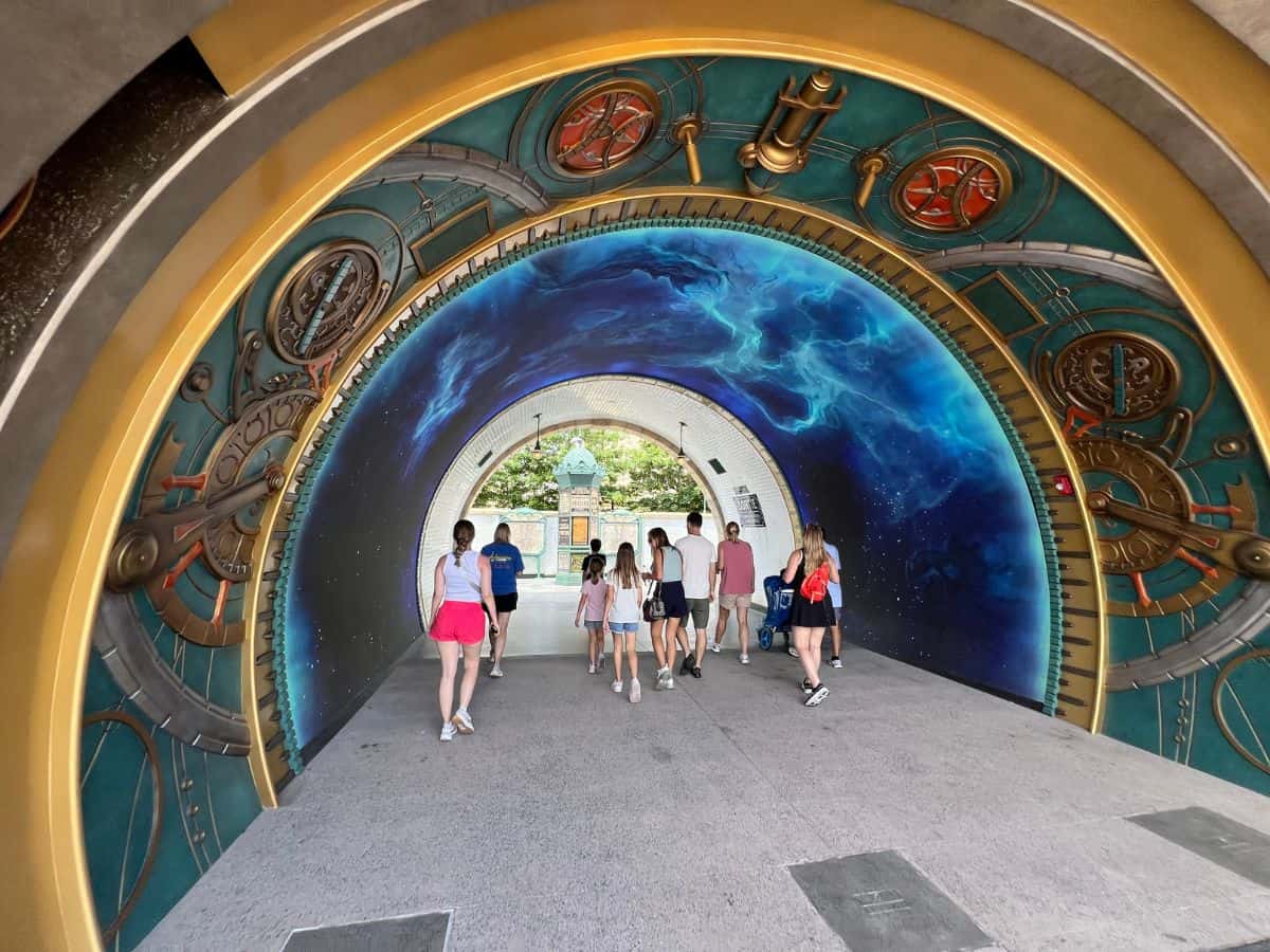 Visitors walk through The Wizarding World of Harry Potter - Ministry of Magic portal in Epic Universe, Orlando, Florida.