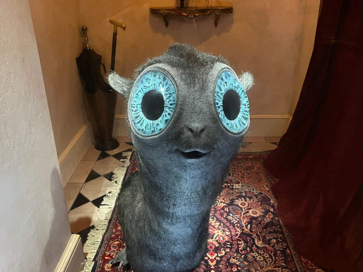 A magical creature called a mooncalf looks at visitors in Ministry of Magic, Epic Universe.