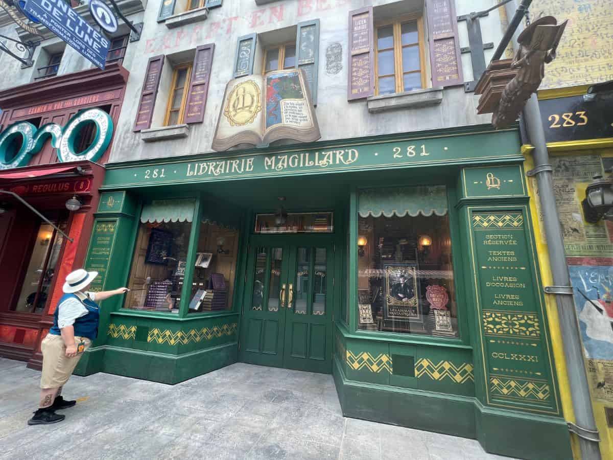 An Epic Universe employee demonstrates how to cast a spell with an interactive wand.