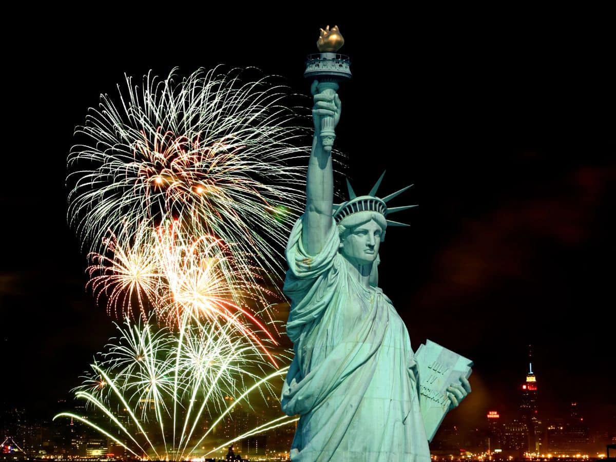 Fireworks light up the sky behind the Statue of Liberty