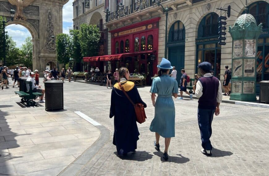Wizarding students walk the streets of 1920s Paris in Epic Universe, Orlando, FL.