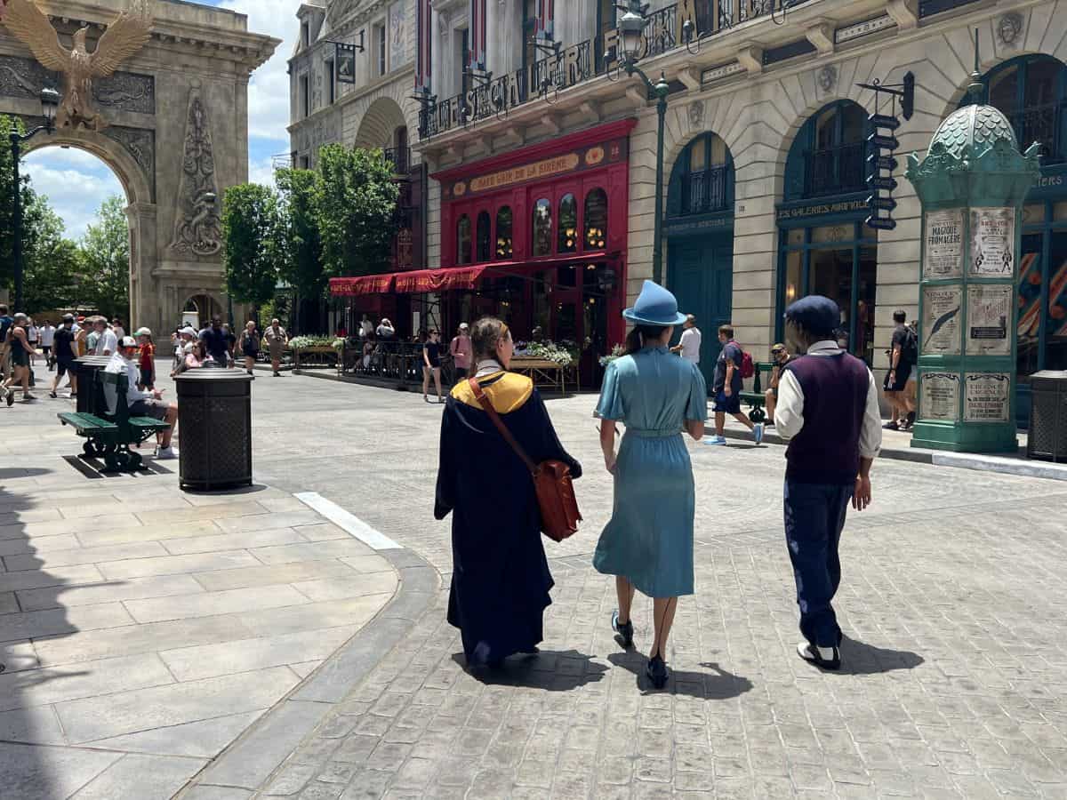 Wizarding students walk the streets of 1920s Paris in Epic Universe, Orlando, FL.