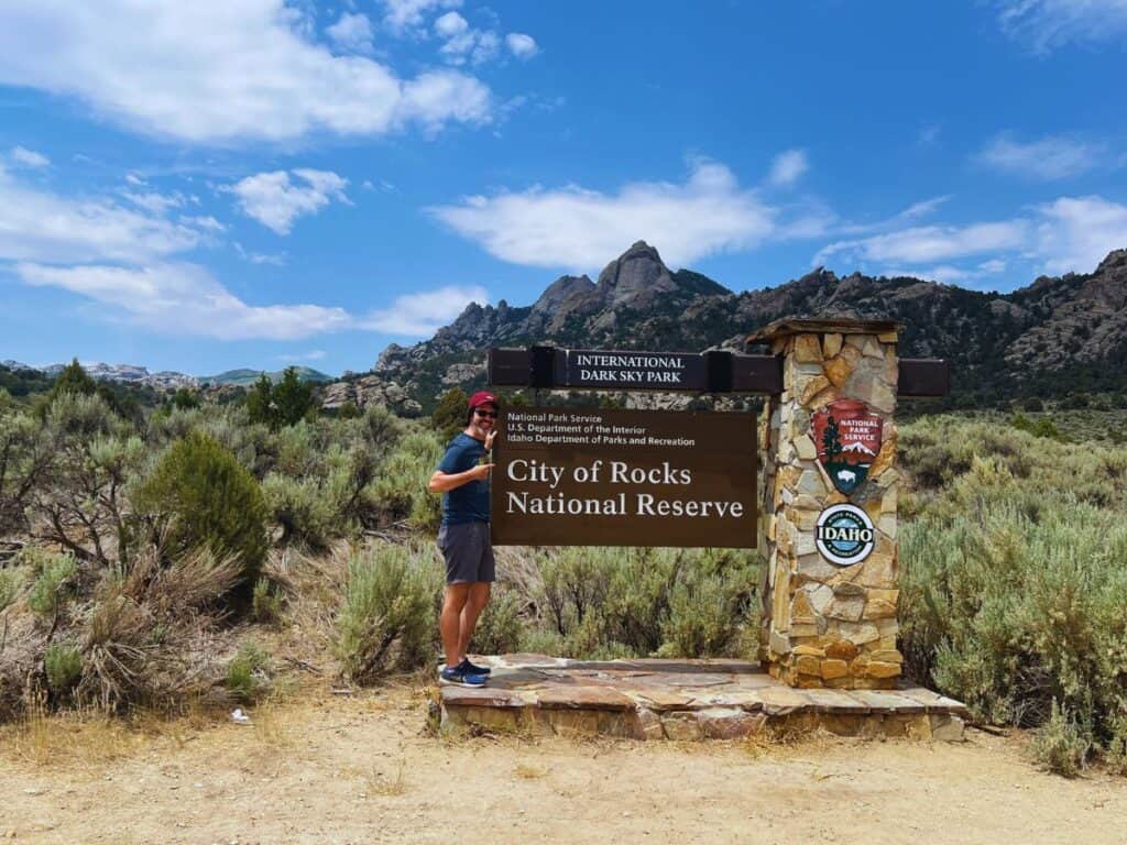 A man points to the City of Rocks sign - a national park site that is a paradise for rock climbers but offers many other things to do.