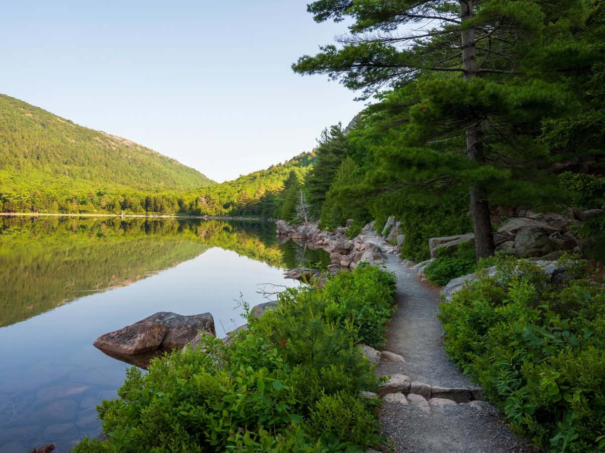 A path loops around a peaceful lake in Acadia National Park