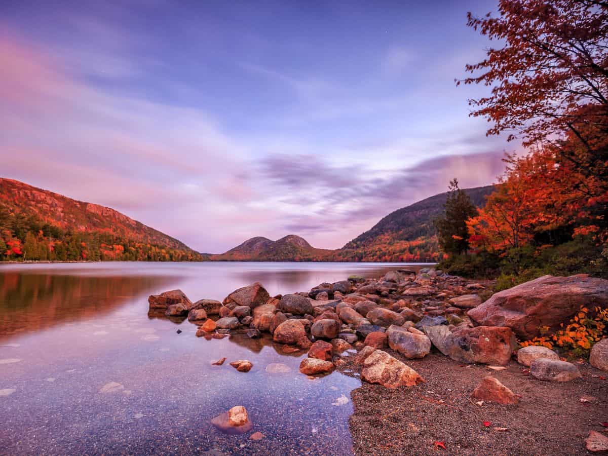 Autumn leaves adorn trees surrounding Jordan Pond, Acadia National Park, ME