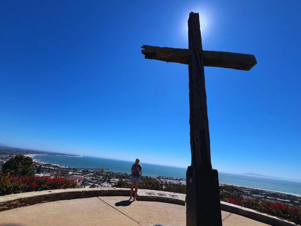 A woman enjoys the coastal view from Serra Cross in Grant Park, Ventura, California.