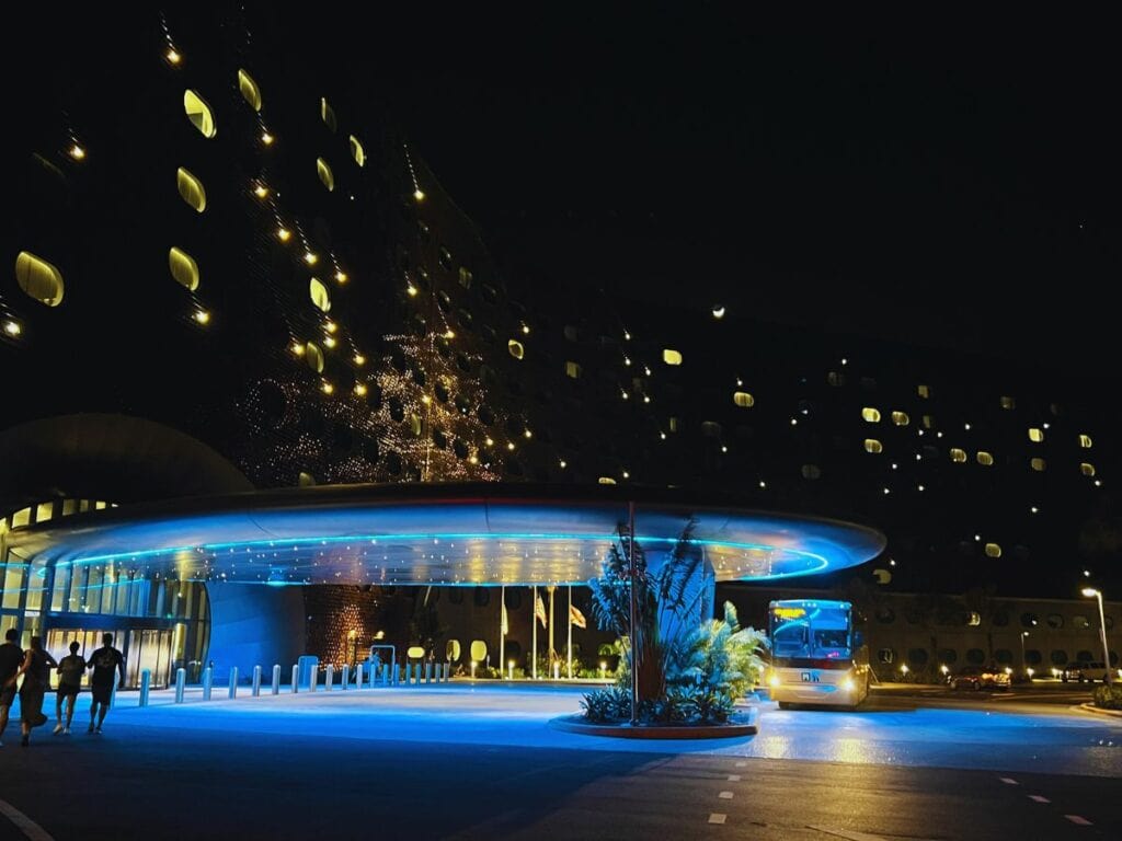 A hotel glows with portal windows and tile lights, giving it a cosmic feel