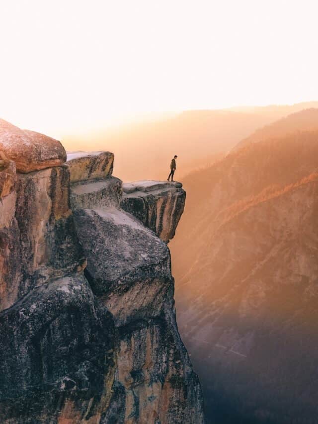 person standing near cliff in rocky mountain national park