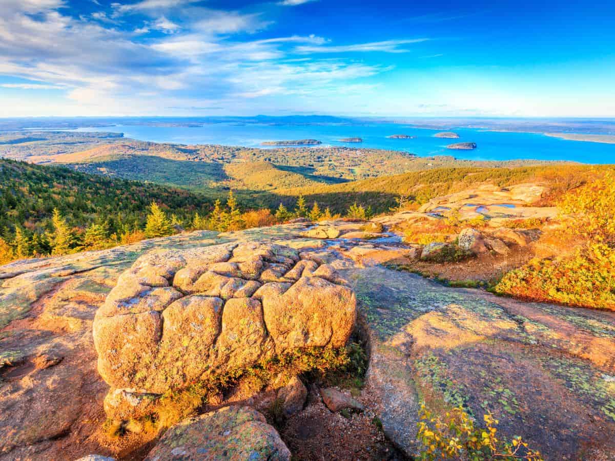 Blue waters and small islands appear on the horizon - the view from Cadillac Mountain, Acadia National Park