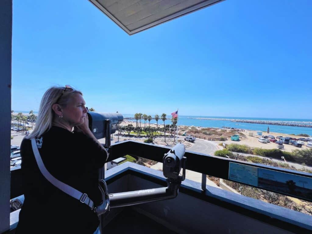 A woman prepares to use the binocular station to view Channel Islands from the upper deck of the park's visitor center in Ventura, CA.