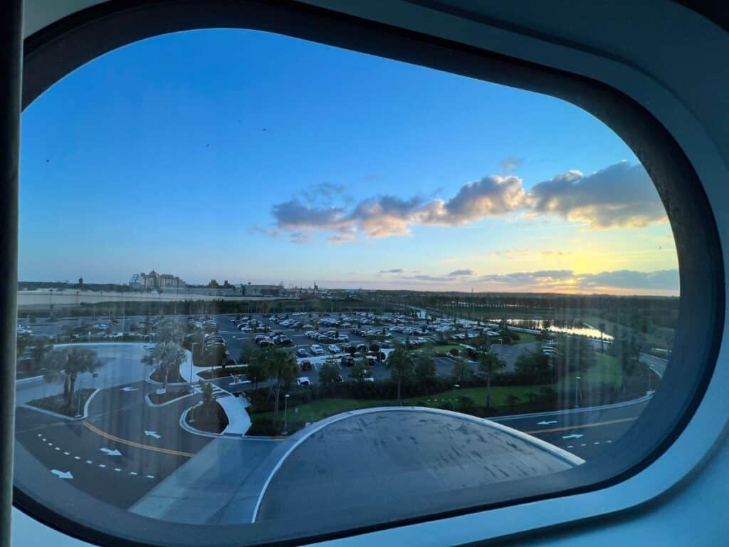 A portal window in Universal Stella Nova Resort reveals Epic Universe in the distance