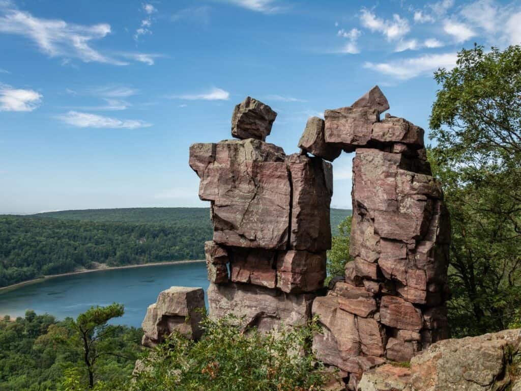 Two towering rock formation rise above a lake below