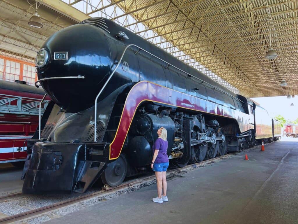 A woman stares up at a large locomotive at the Virginia Museum of Transportation - one of America's most unique transportation museums
