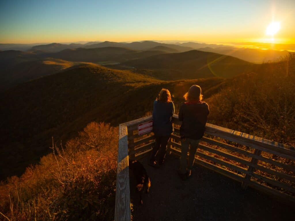 Two people enjoy the view of mountain ridges in Elk Knob State Park