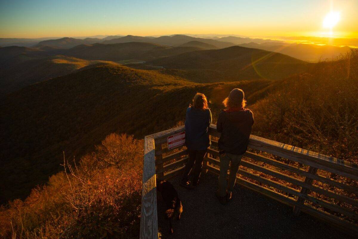 Two people enjoy the view of mountain ridges in Elk Knob State Park