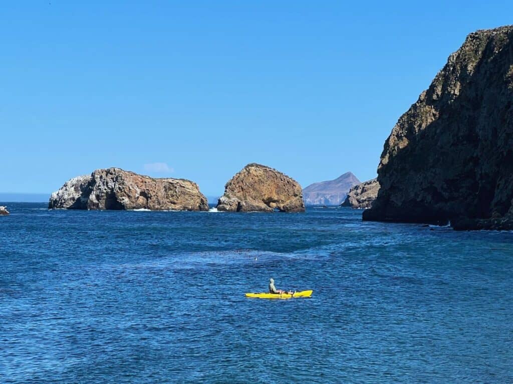 A Channel Islands National Park visitor kayaks along the rugged coast.