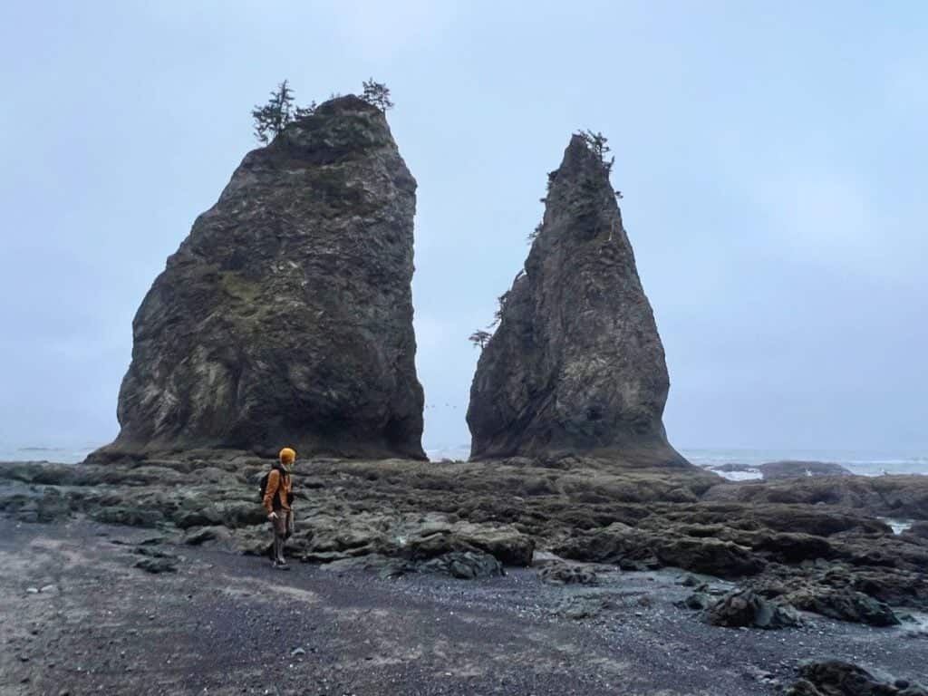 A man walks past Split Rock, an iconic attraction in Olympic National Park.