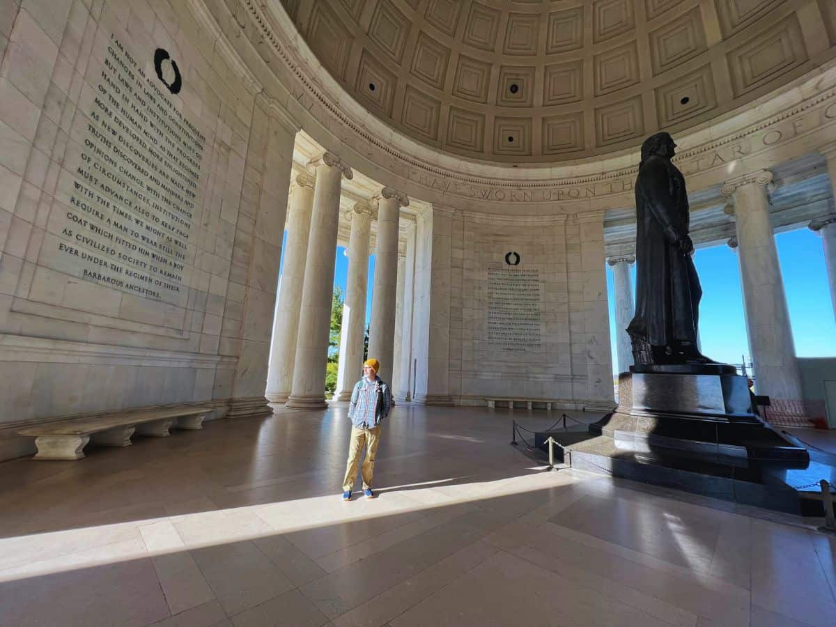 A man walks through the Jefferson Memorial.