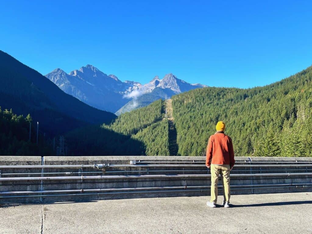 A man pauses to take in the view from the top of Ross Dam, North Cascades National Park.
