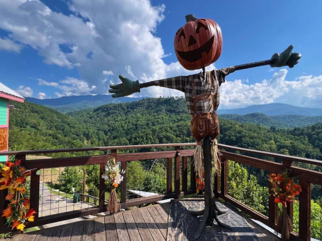 A large scarecrow stands along an Anakeesta overlook with views of the Great Smoky Mountains.