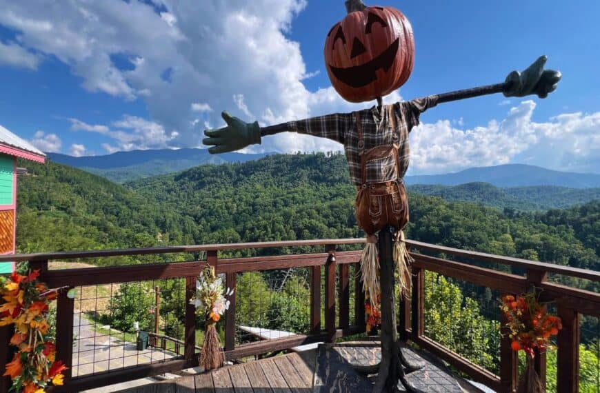 A large scarecrow stands along an Anakeesta overlook with views of the Great Smoky Mountains.